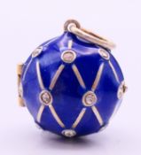 A silver and blue enamel ball locket. 2 cm high.