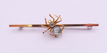A 9 ct gold spider bar brooch. 6.5 cm long. 3.5 grammes total weight.
