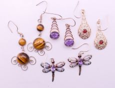 Four pairs of silver earrings. Dragonfly earrings 2.5 cm high.