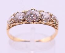 An unmarked gold five stone diamond ring. Ring size P/Q, diamond approximately 0.5 carats.