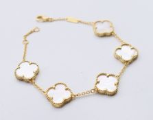 A silver gilt and mother-of-pearl clover bracelet. 18 cm long.