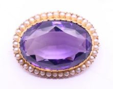 A 15 ct gold amethyst and seed pearl brooch/pendant. 3.5 cm x 2.5 cm.