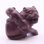 A netsuke in the formed as a dog-of-fo. 3.5 cm high.