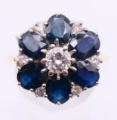 An 18 ct gold, diamond and sapphire cluster ring. Ring size N/O.