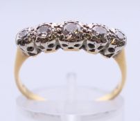 An 18 ct gold and diamond five-stone ring. Ring size N/O.
