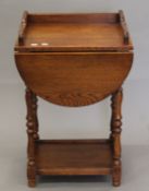 An oak side table with single front flap. 50 cm wide.