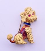 An 18 ct gold poodle dog brooch with ruby set eyes and enamel decoration.. 2.75 cm high. 8.