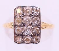 An unmarked gold and diamond ring. Ring size P/Q.