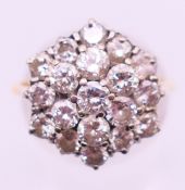An 18 ct gold diamond cluster ring. Ring size P.