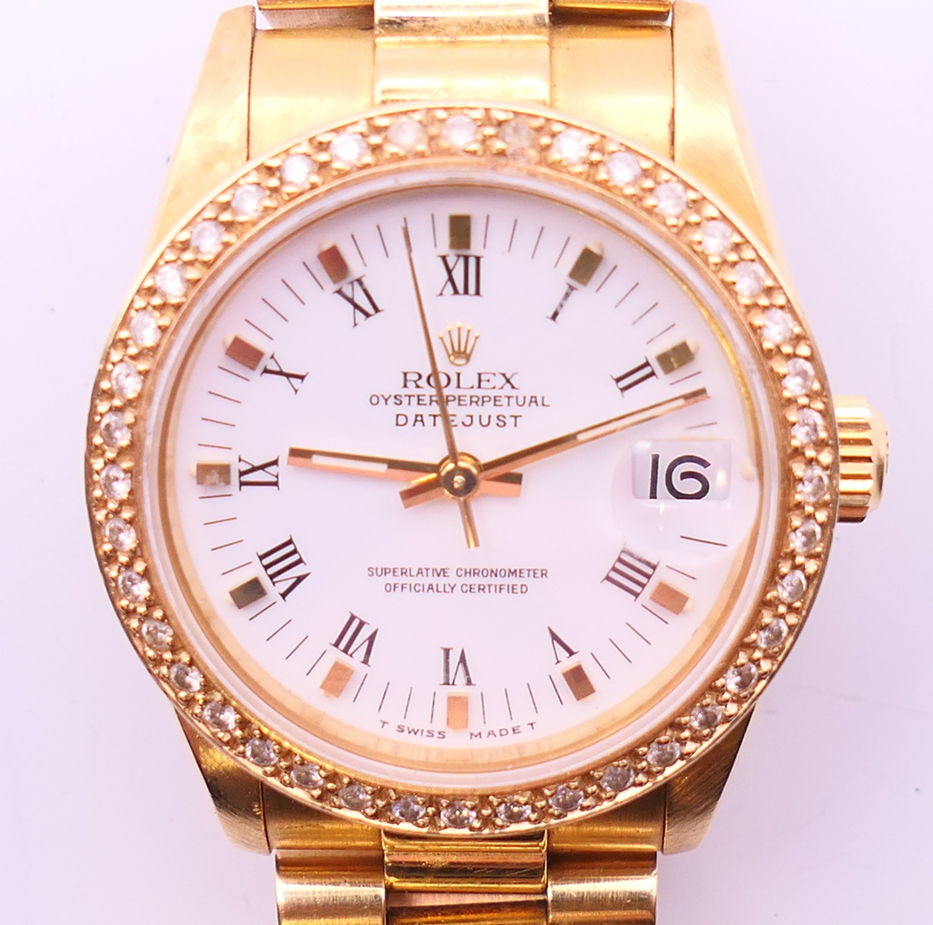 An 18 ct gold Rolex Oyster Perpetual Datejust chronometer wristwatch with associated diamond bezel