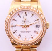 An 18 ct gold Rolex Oyster Perpetual Datejust chronometer wristwatch with associated diamond bezel