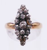 A Victorian unmarked gold and diamond navette ring, the seventeen old cut diamonds set in silver.