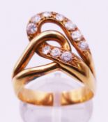An unmarked gold and diamond ring. Ring size Q/R. 6.5 grammes total weight.