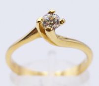 An unmarked gold and diamond solitaire ring. Ring size O/P. 3.4 grammes total weight.