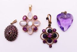 Four various gem set pendants. Largest 3.75 cm high including suspension loop.