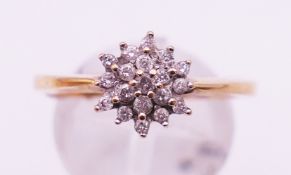 A 9 ct gold diamond cluster ring. Ring size Q. 3.3 grammes total weight.