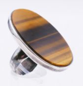 A silver and large oval tigers eye ring. Tigers eye 4 cm x 2.5 cm. Ring size O/P.