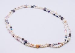 A multi-coloured mixed pearl necklace, in a Mille Perle black pouch. 150 cm long.