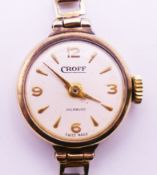 A 9 ct gold Croff ladies wristwatch with a 9 ct gold strap. 11 grammes total weight. Dial 1.