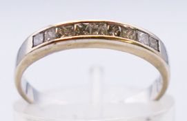 An 18 ct white gold nine stone diamond channel set half eternity ring. Approx 0.25 carat. 1.