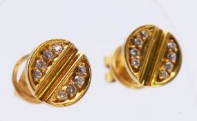 A pair of Cartier style 18 ct gold and diamond ear studs in a Cartier box. Each 1 cm diameter. 4.