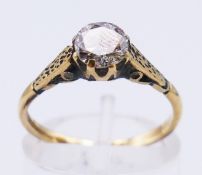An 18 ct gold diamond solitaire ring. Diamond 3/4 carat. 2.5 grammes. Ring size M. (shank split).