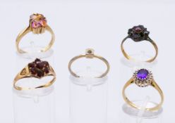 Three 9 ct gold rings an unmarked 9ct gold and garnet ring and a dress ring. 9.