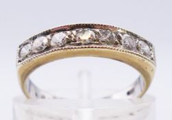 A 9 ct white gold seven stone diamond channel set half eternity ring. Approx 0.28 carat. 2.