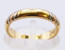 An 18 ct gold wedding band. 3 grammes. Ring size J.