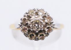 An 18 ct gold diamond cluster ring. Ring size O. 3.4 grammes total weight.