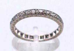 A platinum and diamond eternity ring. Ring size N/0. 3.7 grammes total weight.