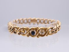 A 15 ct gold, diamond and sapphire set curb link bracelet. 25.8 grammes.