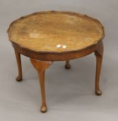 A walnut coffee table. 60 cm diameter x 43 cm high.