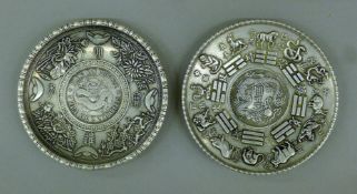 Two Chinese coin dishes. The larger 10 cm diameter.
