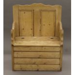 A pine box settle with hinged seat. 74 cm wide.