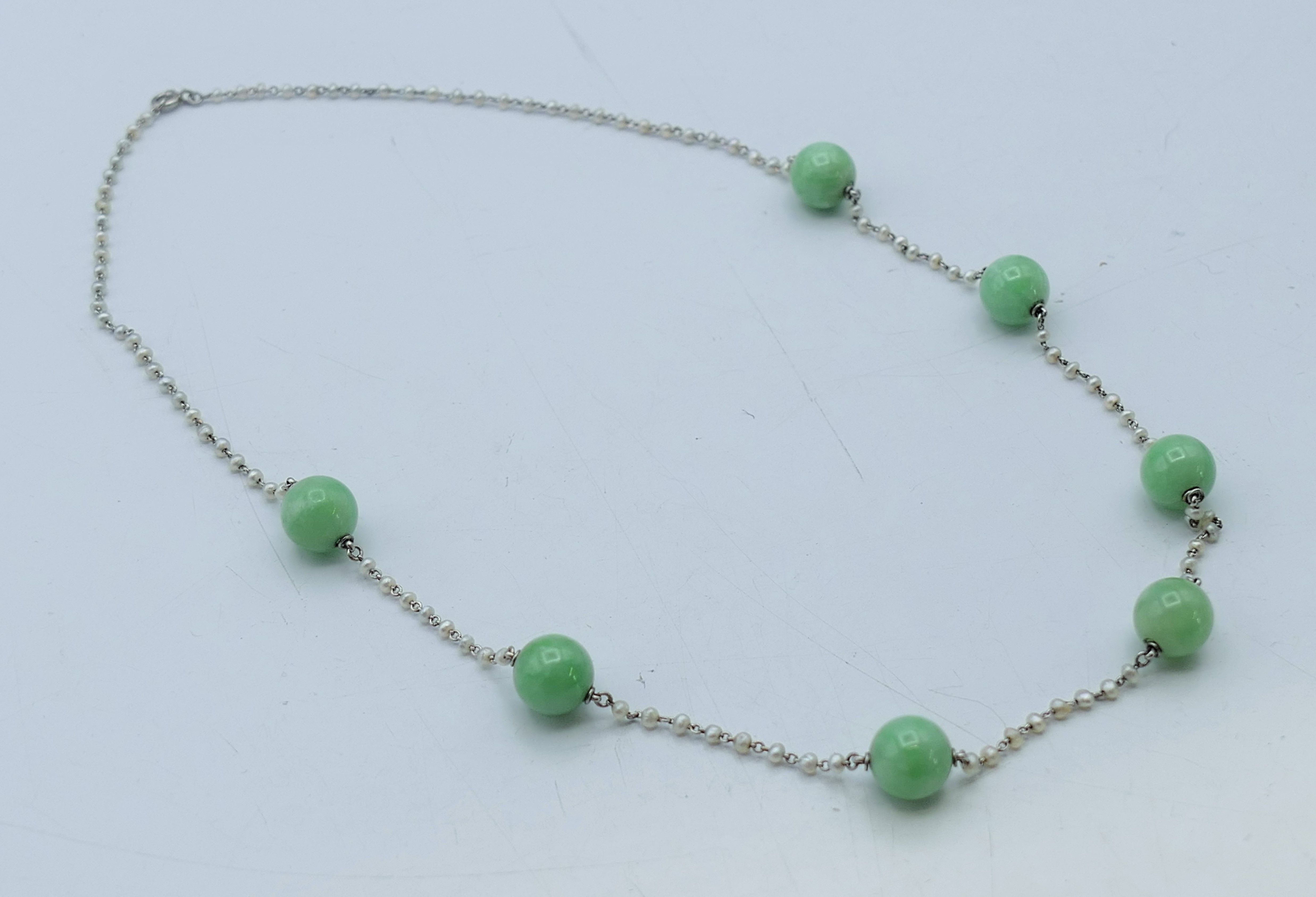 A platinum seed pearl and jade bead necklace. 43 cm long.