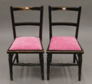 A pair of Victorian ebonised child's chairs. Each 30 cm wide.