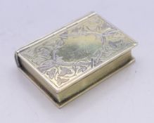 A Victorian silver gilt book form vinaigrette. 3.5 x 2.5 cm.