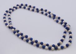 A pearl and lapis lazuli bead necklace. 120 cm long.