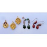 A pair of coral earrings, another pair of earrings and three pendants. Coral earrings 2.5 cm high.