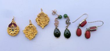 A pair of coral earrings, another pair of earrings and three pendants. Coral earrings 2.5 cm high.