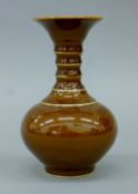 A Chinese brown porcelain vase. 15 cm high.
