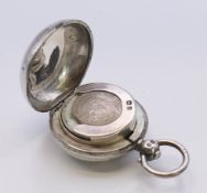 A silver sovereign holder. 4.5 cm high including suspension loop.