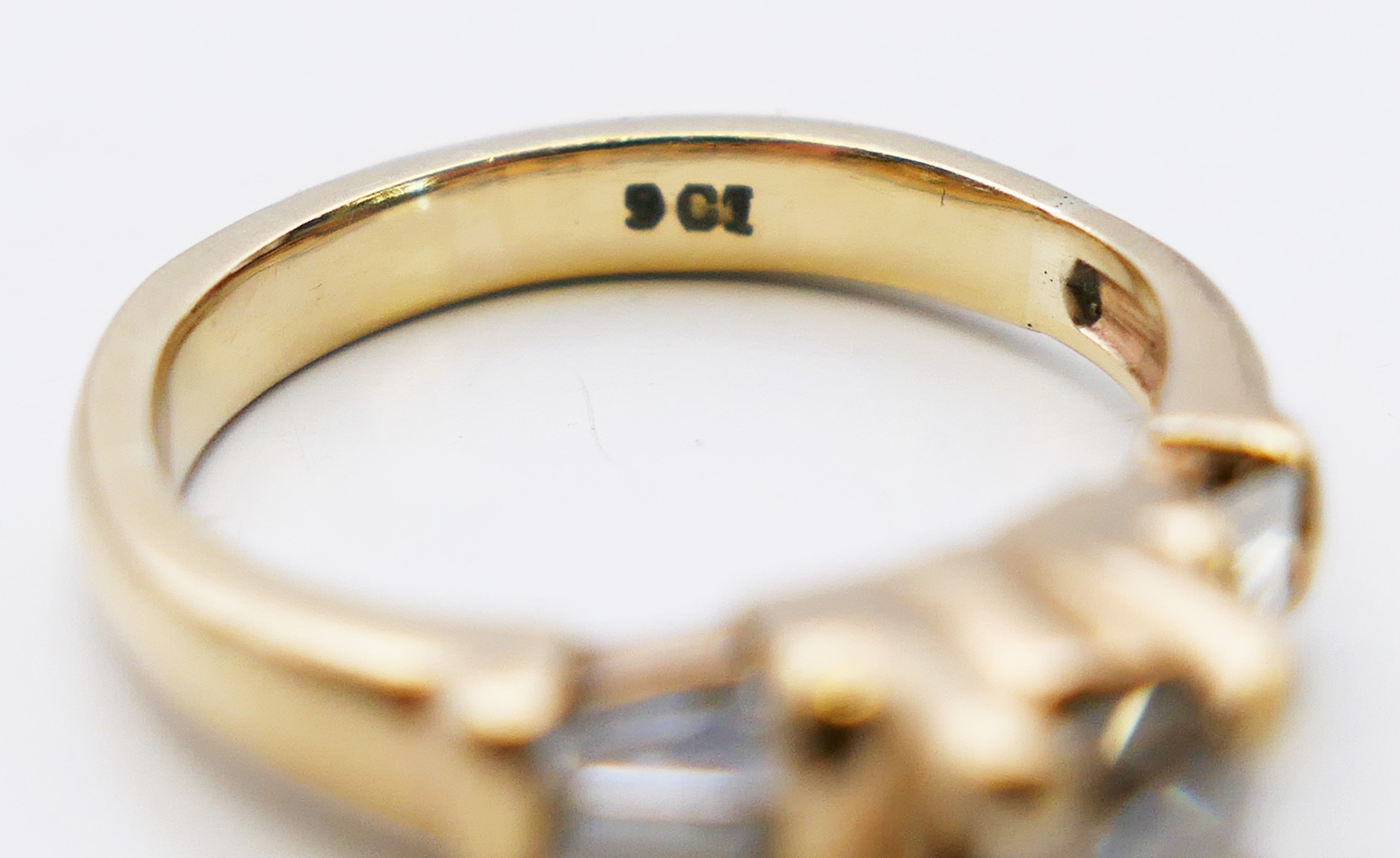 A 9 ct gold diamond solitaire with trapeze cut diamond shoulders. 3.8 grammes. Ring size L. - Image 4 of 5