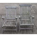 A pair of folding wooden garden chairs with footrests. 59.5 cm wide.