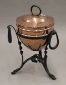 An Arts and Crafts copper coal scuttle/jardiniere on an iron stand. 59 cm high.