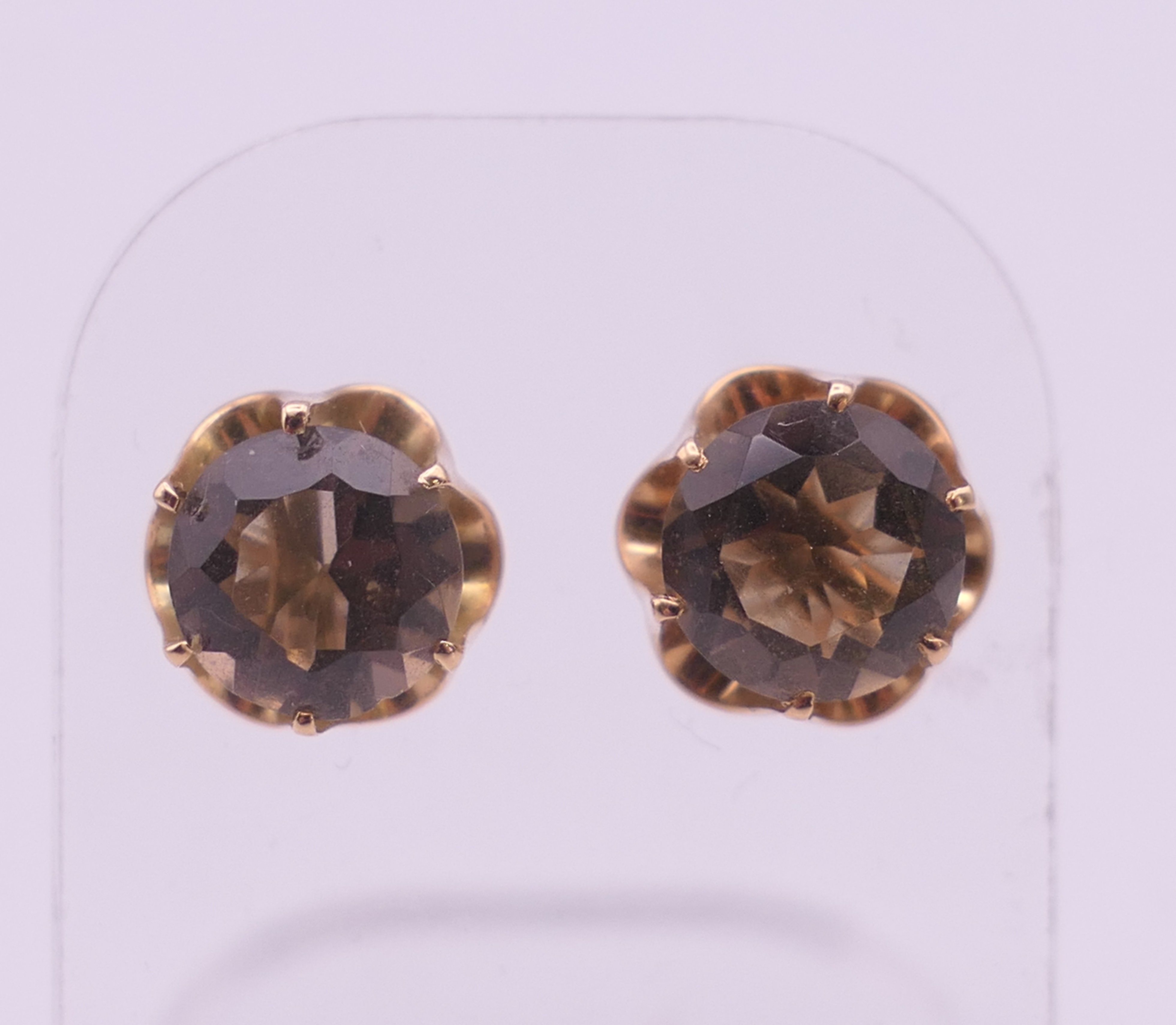 A pair of 14 ct gold and smoky quartz ear studs. 1 cm diameter. 2.5 grammes total weight.