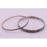 Two silver bangles. 0.7 cm high and 0.3 cm high respectively.