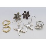 Four pairs of silver earrings. Sunflower earrings approximately 2 cm diameter.