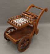 A tiled wooden drinks trolley. 48 cm wide.